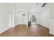 Open entryway with luxury vinyl plank flooring, white walls, arched doorways and modern lighting at 9422 Clover Glen Dr, Riverview, FL 33569