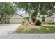 Charming single-story home with manicured lawn and mature trees creating a welcoming curb appeal at 9422 Clover Glen Dr, Riverview, FL 33569