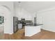 Modern kitchen featuring white cabinets, granite countertops, stainless steel appliances, and wood floors at 9422 Clover Glen Dr, Riverview, FL 33569