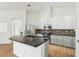Modern kitchen with white cabinets, granite countertops, stainless steel appliances, and wood floors at 9422 Clover Glen Dr, Riverview, FL 33569