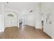 Spacious living room featuring luxury vinyl plank flooring, white walls, arched doorways and modern lighting at 9422 Clover Glen Dr, Riverview, FL 33569
