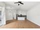 Open-concept living room featuring wood floors and a view of the modern kitchen at 9422 Clover Glen Dr, Riverview, FL 33569