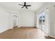 Bright living room featuring wood floors, white walls, and a sliding glass door to the backyard at 9422 Clover Glen Dr, Riverview, FL 33569