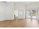 Bright living room featuring luxury vinyl plank flooring, white walls and large sliding glass doors to backyard at 9422 Clover Glen Dr, Riverview, FL 33569
