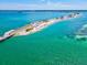 Picturesque aerial view of a coastal bridge with palm trees and crystal-clear ocean waters at 946 Highland Ave # 24, Dunedin, FL 34698