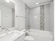 Bathroom featuring a tub, shower with mosaic, and a vanity sink at 946 Highland Ave # 24, Dunedin, FL 34698