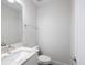A clean white bathroom is designed with a wide mirror, and modern vanity with a chrome faucet and toilet at 946 Highland Ave # 24, Dunedin, FL 34698