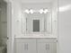 Bathroom featuring double sinks, white cabinets, and plenty of vanity countertop space at 946 Highland Ave # 24, Dunedin, FL 34698