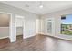 Bright bedroom featuring hardwood floors, neutral paint, ceiling fan, natural light, closet and balcony at 946 Highland Ave # 24, Dunedin, FL 34698