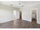 Light bedroom with ensuite bathroom, walk-in closet, neutral walls, and laminate floors at 946 Highland Ave # 24, Dunedin, FL 34698