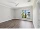 Bright bedroom features hardwood floors, neutral paint, a ceiling fan, and natural light at 946 Highland Ave # 24, Dunedin, FL 34698
