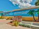 A Dunedin community mural showcasing a beach scene with palm trees and the town name at 946 Highland Ave # 24, Dunedin, FL 34698