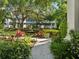 Community courtyard with lush tropical foliage, stone pathway, and inviting gazebo, perfect for relaxation at 946 Highland Ave # 24, Dunedin, FL 34698