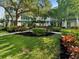 Expansive courtyard with lush grass, mature landscaping, and inviting gazebo for serene relaxation at 946 Highland Ave # 24, Dunedin, FL 34698