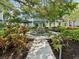 Serene courtyard featuring a stone fountain, lush tropical landscaping, and a charming gazebo for relaxing at 946 Highland Ave # 24, Dunedin, FL 34698