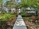 Scenic courtyard with walking path, gazebo and lush greenery creates a peaceful community gathering space at 946 Highland Ave # 24, Dunedin, FL 34698