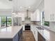 Well-lit kitchen features white cabinets, stainless appliances, a breakfast bar, and a double oven at 946 Highland Ave # 24, Dunedin, FL 34698