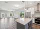 Open-concept living and kitchen area with hardwood floors and modern fixtures at 946 Highland Ave # 24, Dunedin, FL 34698