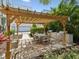 Community space with a large wooden pergola that shelters an outdoor table and stainless steel grill at 946 Highland Ave # 24, Dunedin, FL 34698