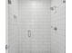 Walk-in shower features white subway tiles, a glass door, and modern fixtures at 946 Highland Ave # 24, Dunedin, FL 34698