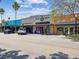 Colorful street featuring a mix of unique shops with pedestrian walkways and ample parking at 946 Highland Ave # 24, Dunedin, FL 34698