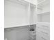 Custom walk-in closet with adjustable shelving, drawers, and hanging rods for ample storage at 946 Highland Ave # 24, Dunedin, FL 34698