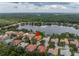 Aerial view of a lakeside home showing the private neighborhood and mature tree coverage at 9818 Tree Tops Lake Rd, Tampa, FL 33626