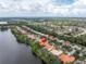 An aerial view shows a lakeside property in a neighborhood near a forest preserve at 9818 Tree Tops Lake Rd, Tampa, FL 33626