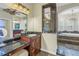 Bathroom with a vanity, glass shower, and large soaking tub with arched windows that provide natural light at 9818 Tree Tops Lake Rd, Tampa, FL 33626