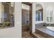 Elegant bathroom featuring a luxurious bathtub and a separate tiled shower with bronze fixtures at 9818 Tree Tops Lake Rd, Tampa, FL 33626