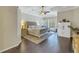 Comfortable bedroom with a king bed, hardwood floors, a ceiling fan, and a sitting area at 9818 Tree Tops Lake Rd, Tampa, FL 33626