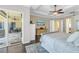 Light-filled bedroom with access to the lanai and features a mounted TV and ceiling fan at 9818 Tree Tops Lake Rd, Tampa, FL 33626