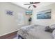 Relaxing bedroom with hardwood floors, a TV, and a calming color scheme at 9818 Tree Tops Lake Rd, Tampa, FL 33626