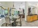 Dining room with glass table and views to the living room and lanai at 9818 Tree Tops Lake Rd, Tampa, FL 33626