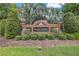Landscaped brick entrance to Tree Tops community with signage and manicured bushes at 9818 Tree Tops Lake Rd, Tampa, FL 33626