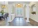 Bright and airy foyer featuring tile floors, arched doorways and decorative light fixture at 9818 Tree Tops Lake Rd, Tampa, FL 33626