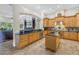 Spacious kitchen featuring wood cabinets, granite countertops, and modern appliances at 9818 Tree Tops Lake Rd, Tampa, FL 33626