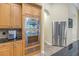 Modern kitchen featuring stainless steel oven, granite countertops, and wood cabinetry at 9818 Tree Tops Lake Rd, Tampa, FL 33626