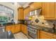 Gourmet kitchen with stainless steel appliances, custom cabinetry, and granite countertops at 9818 Tree Tops Lake Rd, Tampa, FL 33626