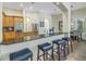 Kitchen bar with granite countertops and seating for entertaining at 9818 Tree Tops Lake Rd, Tampa, FL 33626