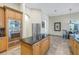 Kitchen features built-in oven, island with black granite, and view of dining area at 9818 Tree Tops Lake Rd, Tampa, FL 33626