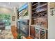 Living room with fireplace, custom built-ins, and a wine fridge at 9818 Tree Tops Lake Rd, Tampa, FL 33626