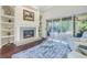 Comfortable living room with fireplace and sliding glass doors to the pool and outdoor living area at 9818 Tree Tops Lake Rd, Tampa, FL 33626