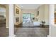 Open living room features tall ceilings, a fireplace, hardwood floors and access to outdoor patio at 9818 Tree Tops Lake Rd, Tampa, FL 33626