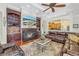 Cozy living room with a fireplace, built in bar, and a comfortable leather sectional at 9818 Tree Tops Lake Rd, Tampa, FL 33626