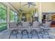 Beautiful outdoor kitchen with stone accents, bar seating, and fireplace at 9818 Tree Tops Lake Rd, Tampa, FL 33626