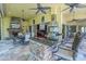 Amazing outdoor kitchen area with a bar, grill, and stone fireplace, perfect for entertaining at 9818 Tree Tops Lake Rd, Tampa, FL 33626
