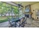 Relaxing screened patio with a stone fireplace and picturesque views of the lake enhances the home's appeal at 9818 Tree Tops Lake Rd, Tampa, FL 33626