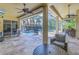 Screened outdoor area with ceiling fans, seating and a view of the pool at 9818 Tree Tops Lake Rd, Tampa, FL 33626