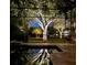 Backyard pool at twilight with screened enclosure and illuminated landscaping creates a serene oasis at 9818 Tree Tops Lake Rd, Tampa, FL 33626